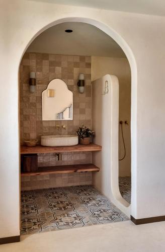 a bathroom with an archway with a tub and a sink at Nomad Hotel & Spa Altea in Altea