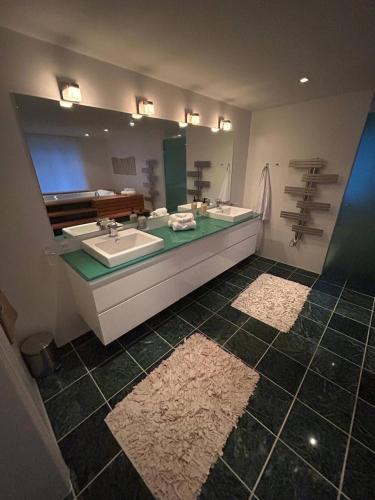 a bathroom with two sinks and a large mirror at Copenhagen Denmark by the Sea Villa Solrd Strand in Solrød Strand