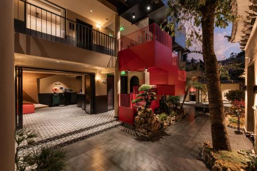 an apartment with a red staircase in a building at SIXI CANGSHAN MOUNTAINS GOLDEN SUNRISE MIRROR OF THE SKY SOUND SLEEP HOTEL DALI ANCIENT CITy in Dali