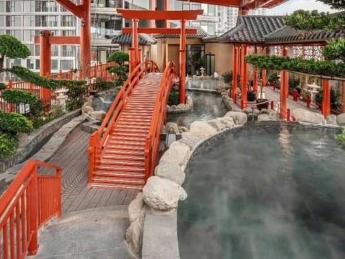 a swimming pool with a slide in a resort at Vườn Tùng RiverSide retreat & Villa - KDT ECOPARK in Kim Quan