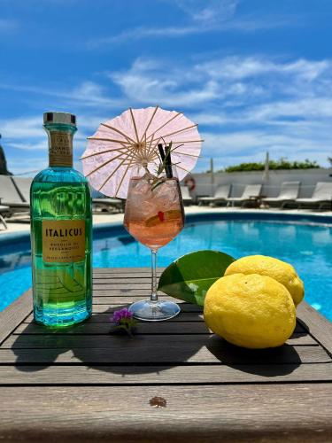 a drink and a bottle of alcohol next to a drink gmaxwell gmaxwell gmaxwell at Hotel Della Piccola Marina in Capri