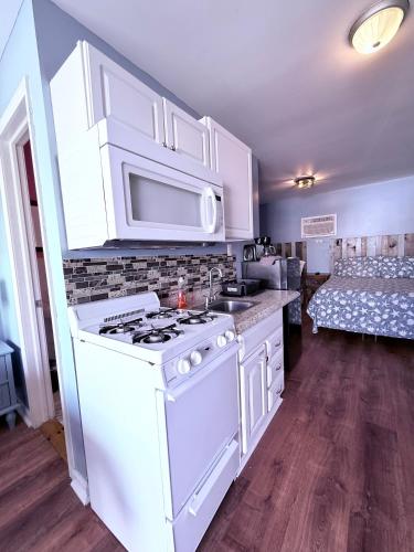 a kitchen with a white stove and a sink at Twilight Motel in Wildwood