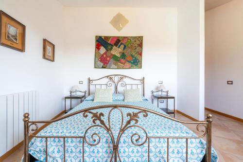 a bedroom with a blue and white bed at Harmònia Residence in Villasimius