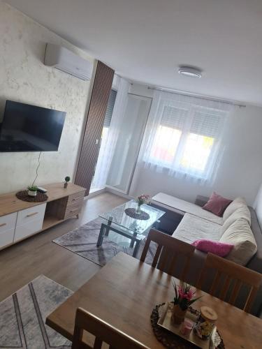 a living room with a couch and a table at Apartman L&S in Doboj