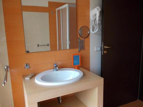 a bathroom with a sink and a mirror at Hotel Catania Town in Catania