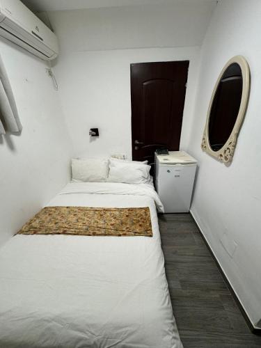 a small room with two beds and a window at Shirat Hayam Boutique Hotel in Tiberias