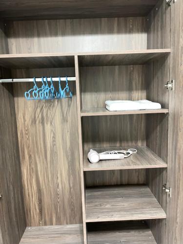 a wooden closet with wooden shelves at 北京之夜华人民宿餐厅 chinese hotel in Banī Ghālib