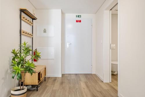 a hallway with a door and a potted plant at Carmo Heritage Apartments in Funchal