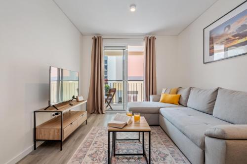 a living room with a couch and a table at Carmo Heritage Apartments in Funchal