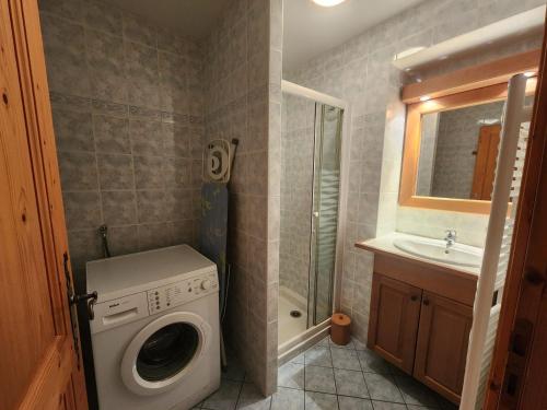 une salle de bain avec une machine à laver et un lavabo dans l'établissement Appartement Vaste 3 Pièces + Cabine, Proche Remontées Mécaniques, Lac et Piscine - Résidence le Pas au Loup - FR-1-629-4, à Samoëns