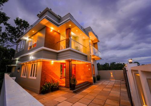 a large house with a driveway in front of it at Oasis Apartment with Pool in Vythiri in Vythiri