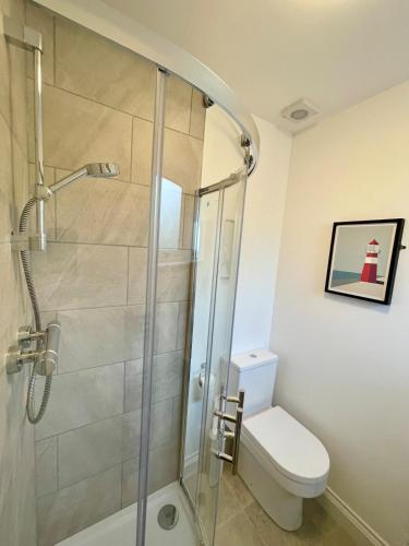 a bathroom with a shower and a toilet at Bright, Spacious 5-Bed, 4-Bathroom home on Loch Soy in Portsoy
