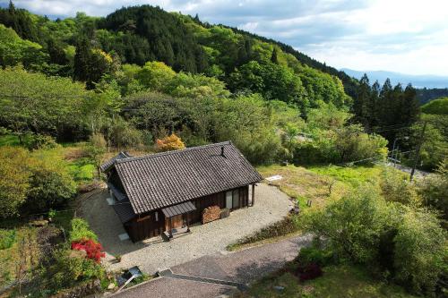 a small house in the middle of a mountain at 峠のお宿 巧の実家 Magome Guest House, Along the Nakasendo Trail in Nakatsugawa