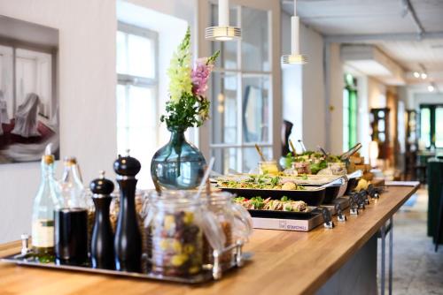 a buffet line with plates of food on a table at Söderlångvik Glamping in Söderlångvik
