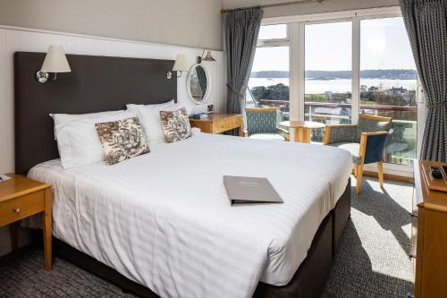 a hotel room with a bed with a laptop on it at Hotel Cristina in St Lawrence