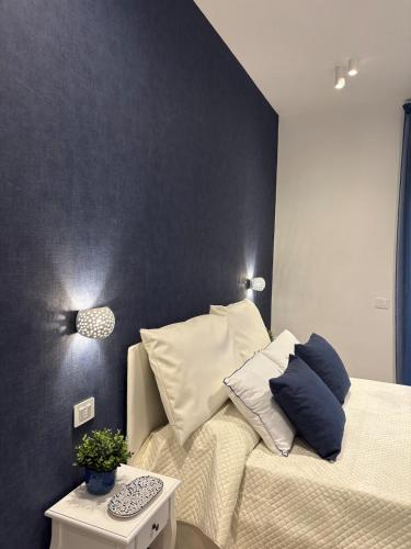 a bedroom with a bed with pillows on it at L'Abbraccio di Parthenope in Torre del Greco
