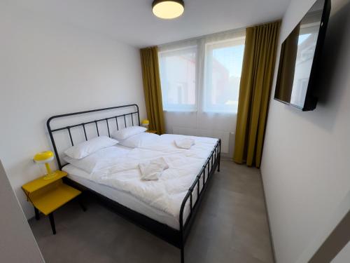 a bedroom with a bed and a window at ROCH800 - industriální aparthotel Klatovy in Klatovy