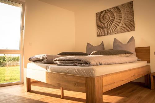 a bed sitting in a room with a window at Ferienwohnen im Ziegelfeld in Niederrotweil