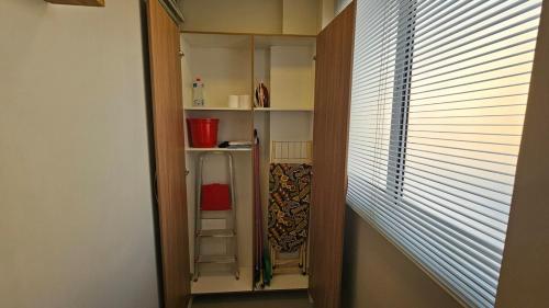 a hallway with a book shelf and a window at Comfort and Practicality Campinas in Campinas