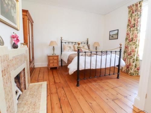 a bedroom with a bed and a fireplace at Mullans in Southport