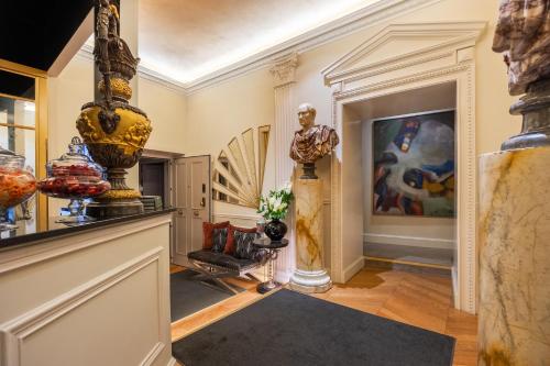a living room with vases on the walls and a hallway at Torre Argentina Relais - Residenze di Charme in Rome