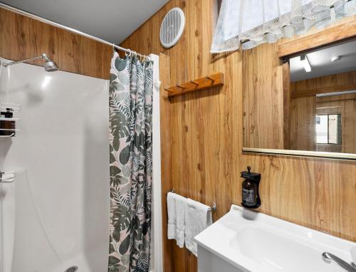 a bathroom with a shower and a white sink at Shepparton Holiday Park and Village in Shepparton