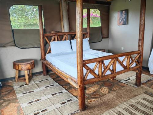 a bedroom with a wooden bunk bed and a table at Living Waters Resort in Jinja