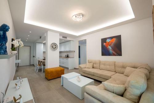 a living room with a couch and a table at Luxury Sea View Apartments in Sarandë