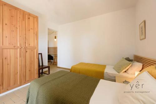 a bedroom with two beds and a chair at 6BR Villa with Private Pool, 4 Baths & Garden -PADMA in Angairiá