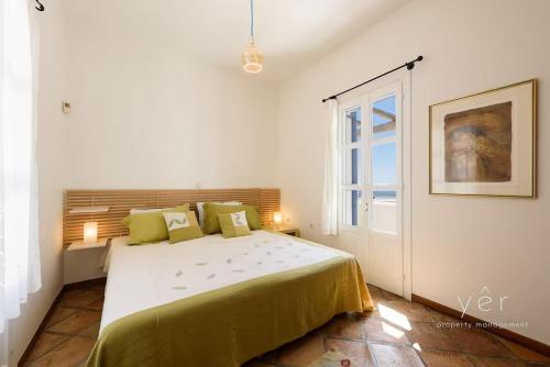 a bedroom with a large bed and a window at 6BR Villa with Private Pool, 4 Baths & Garden -PADMA in Angairiá