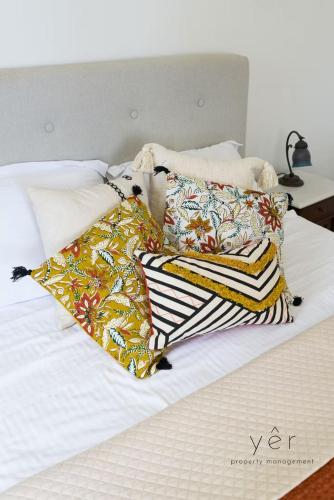 a bed with two pillows on top of it at 6BR Villa with Private Pool, 4 Baths & Garden -PADMA in Angairiá