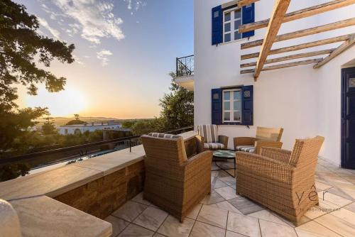 a patio with wicker chairs and a table at 6BR Villa with Private Pool, 4 Baths & Garden -PADMA in Angairiá