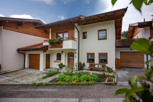 a house with a bench in front of it at Ferienhaus Hirschalmblick in Söll