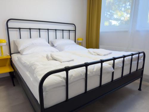 a bed with white pillows on it in a room at ROCH800 - industriální aparthotel Klatovy in Klatovy