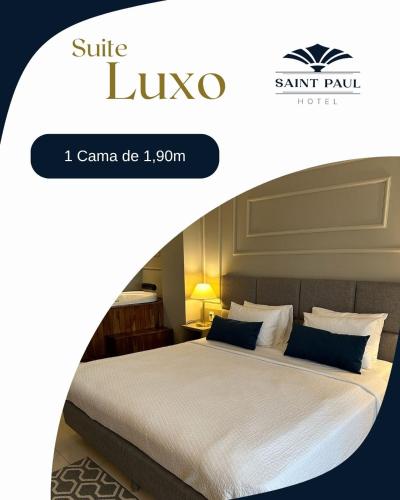 a hotel room with a bed and a sign that says suite luxo at Hotel Saint Paul in Sao Jose do Rio Preto