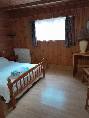 a bedroom with a bed and a large window at Gîte du val d Eygues in Sahune