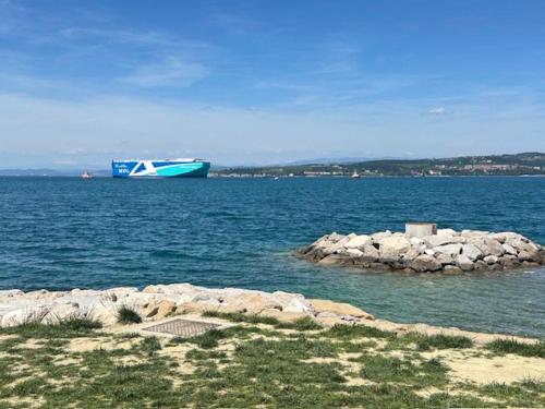 a blue and white boat in a large body of water at At Alex apartment with seaview in Koper