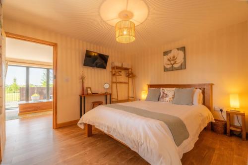 a bedroom with a bed and a large window at The Stables in Firsby
