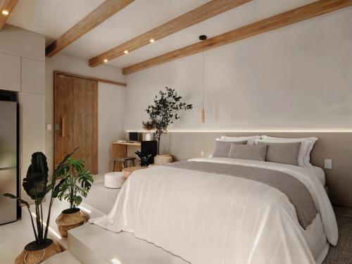 a bedroom with a large white bed in a room at Fátima's Place - Cozy Loft in Old Town Viana in Viana do Castelo