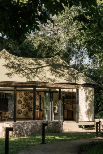 a building with glass doors and a tree at Zambezi Sands by Batoka in Victoria Falls