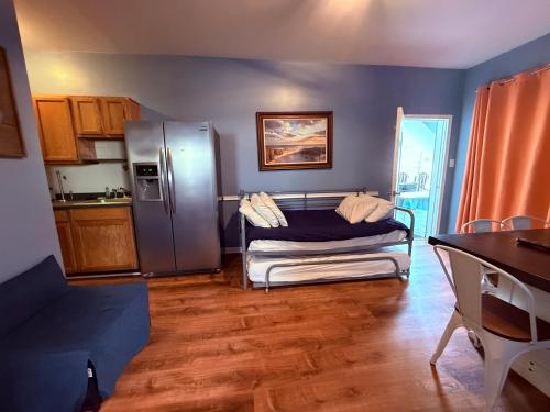 a kitchen with a couch and a stainless steel refrigerator at Twilight Motel in Wildwood