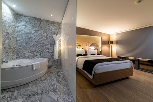 a hotel room with a bed and a bath tub at Hotel Saint Sophia in Istanbul