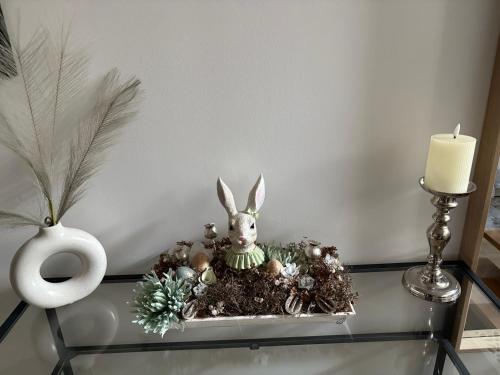 a glass table with a bunny figurine and christmas decorations at Z8 Prémium Apartman in Kaposvár