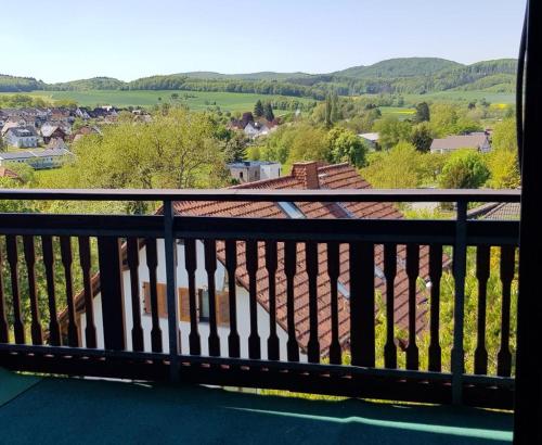 a balcony with a view of a town and hills at NEU! Mietappartement Brusius in Lohra