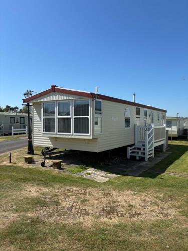 a mobile home with a porch and a deck at WALSHS HOLIDAY PARK, Skegness in Skegness