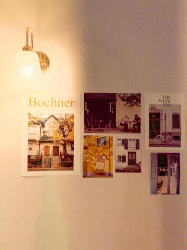 a group of pictures on a wall with a light at Won stay in Osan