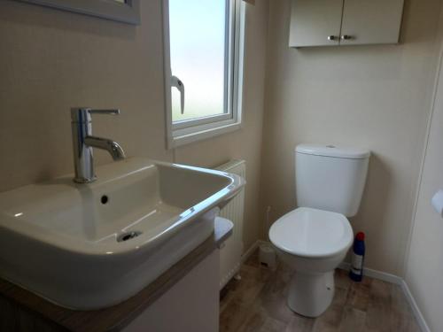 a bathroom with a sink and a toilet at 33 Unity Beach Pet friendly Pets stay free 3 bedrooms sleeps 8 in Brean