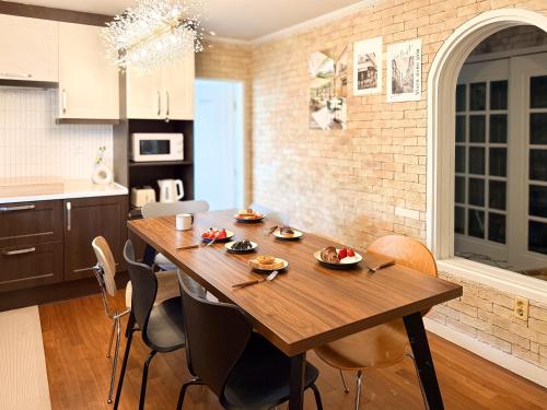 a kitchen with a wooden table and chairs at Won stay in Osan