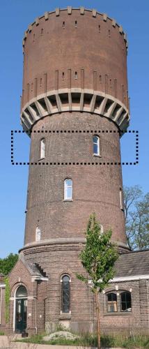 a brick building with a tower on top of it at Watertoren Hengelo in Hengelo
