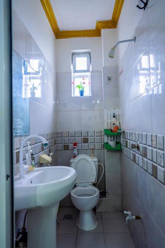 a bathroom with a toilet and a sink at Nayas Haven Studio2 in Mombasa Bamburi Mtambo Mwembeni with hot shower in Mombasa